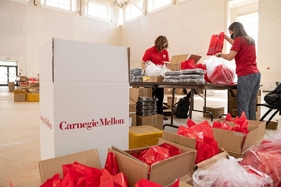 image of white CMU branded box and wellness kits in red bags