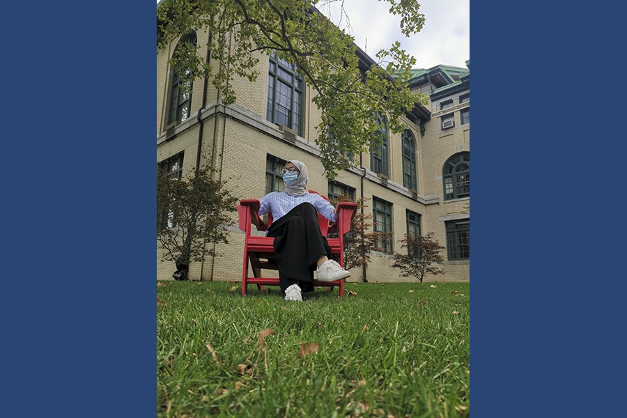 Al Ali sits on campus wearing a mask