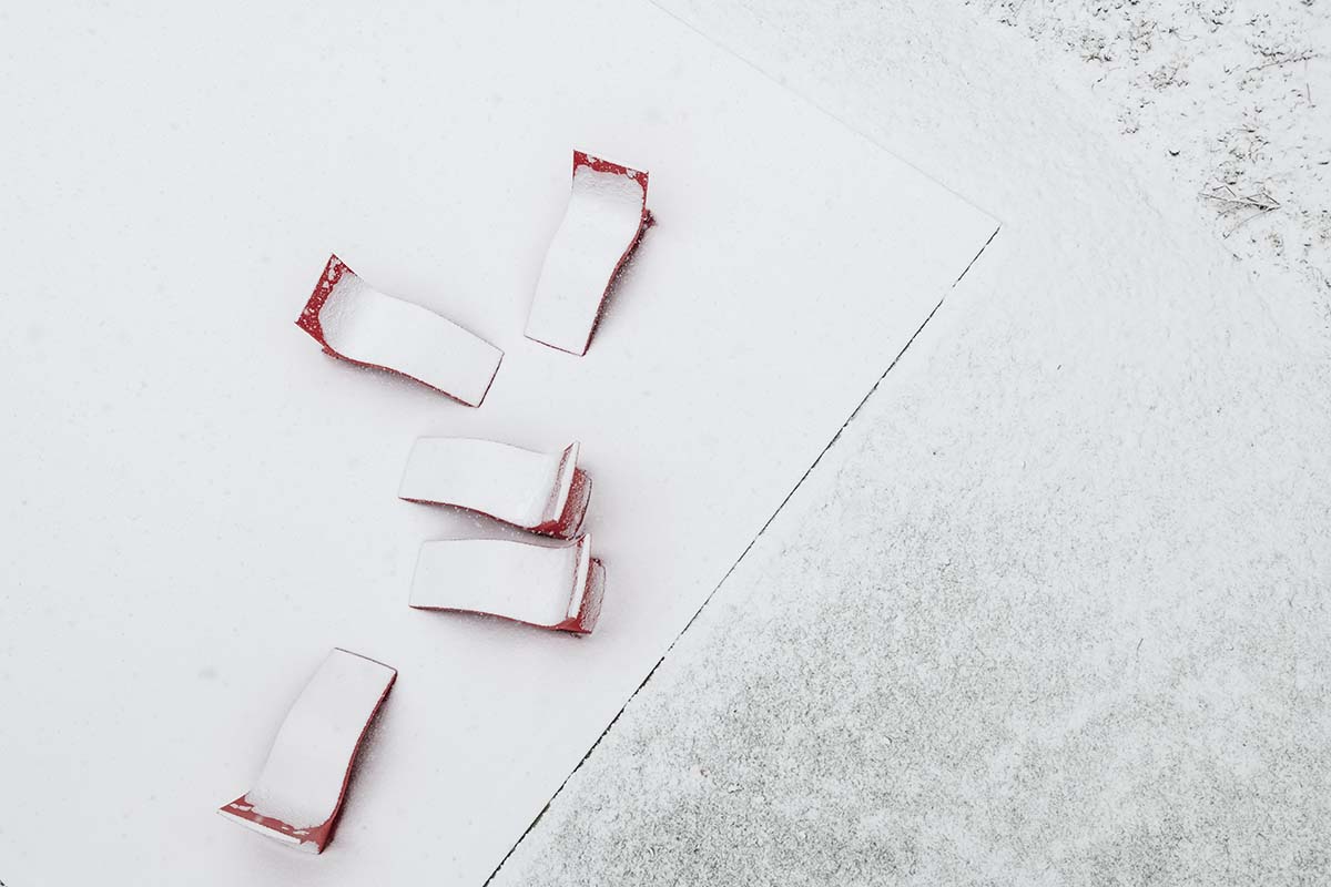 Chairs on campus covered in snow