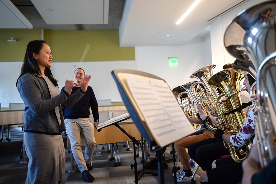an MBA student tries to conduct the tuba band