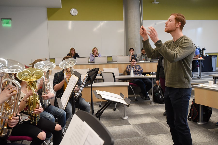 an MBA student conducts the tuba band