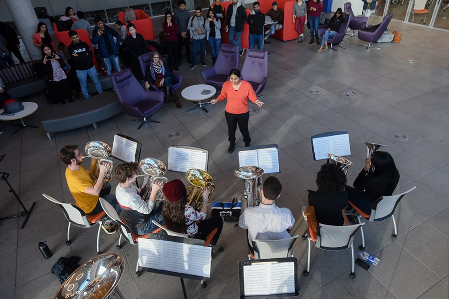 MBA students conduct the tuba band in the Tepper quad