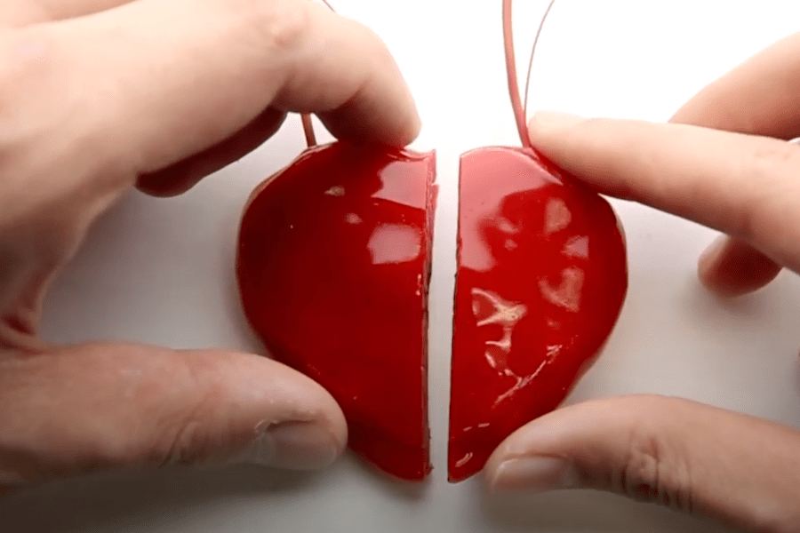 hands holding a red electronic heart