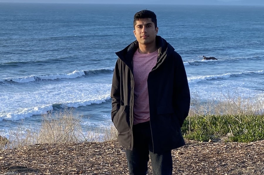 Sean Pereira stands on the beach