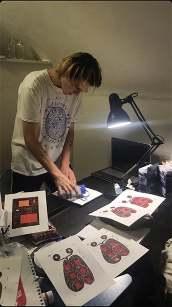 A photo of Wilson Ekern working on his linotype prints.