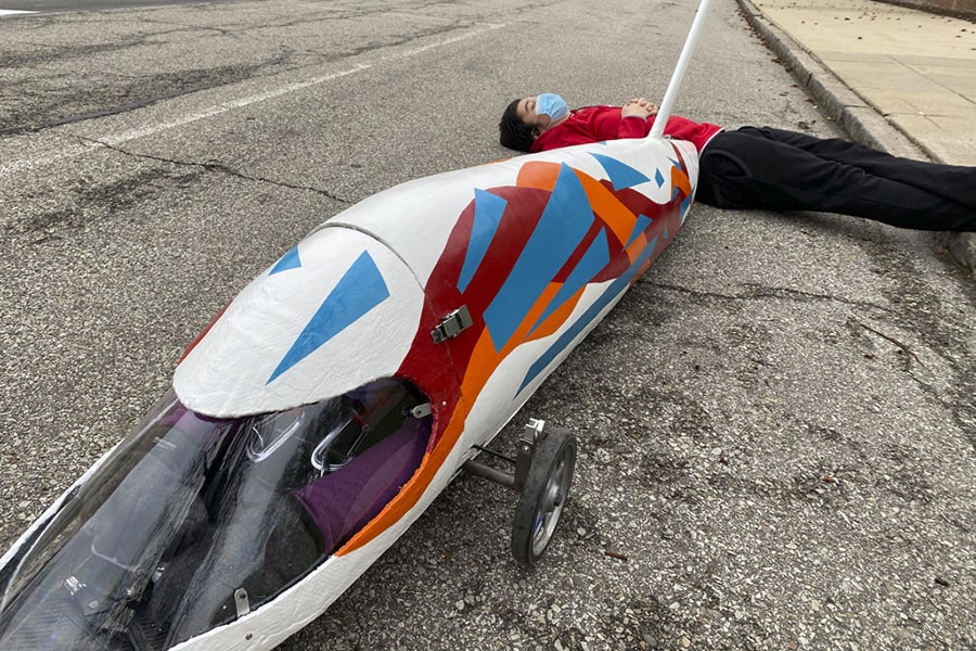 A student rests while waiting for a roll to start.