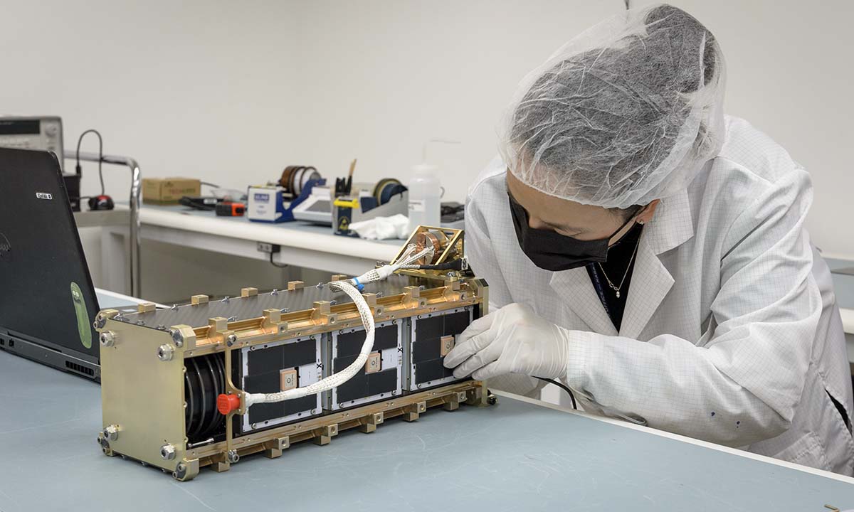 A researcher works on a satellite test