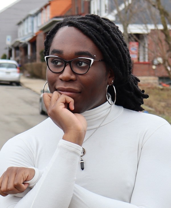 Aurelia Augusta in a white shirt with her chin in her hand