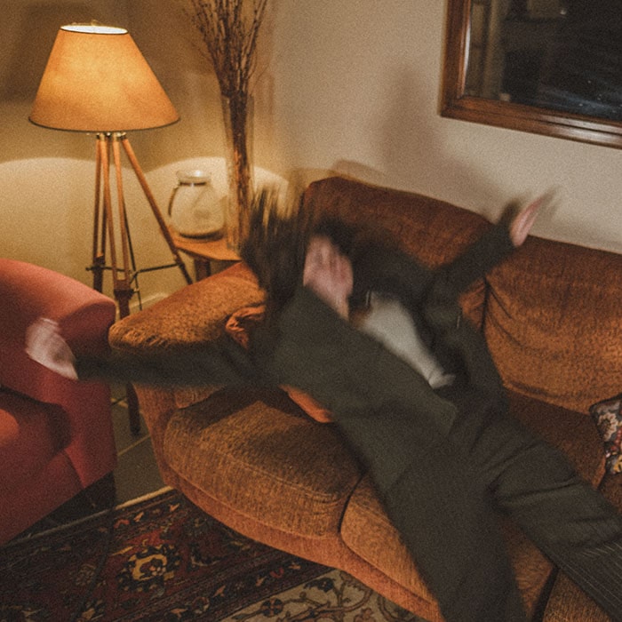 A photo of Jubbies falling onto a couch