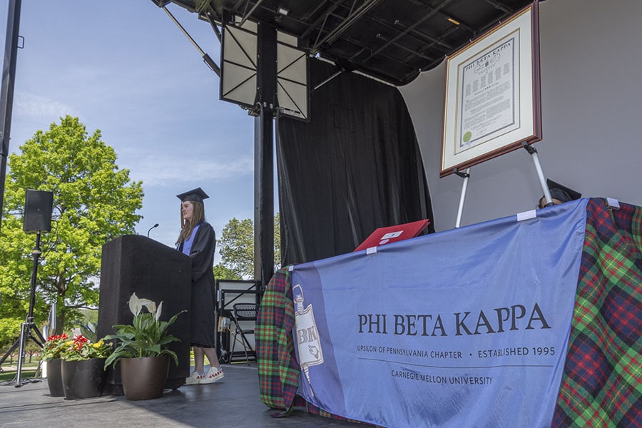 A photo of a speaker at a podium.