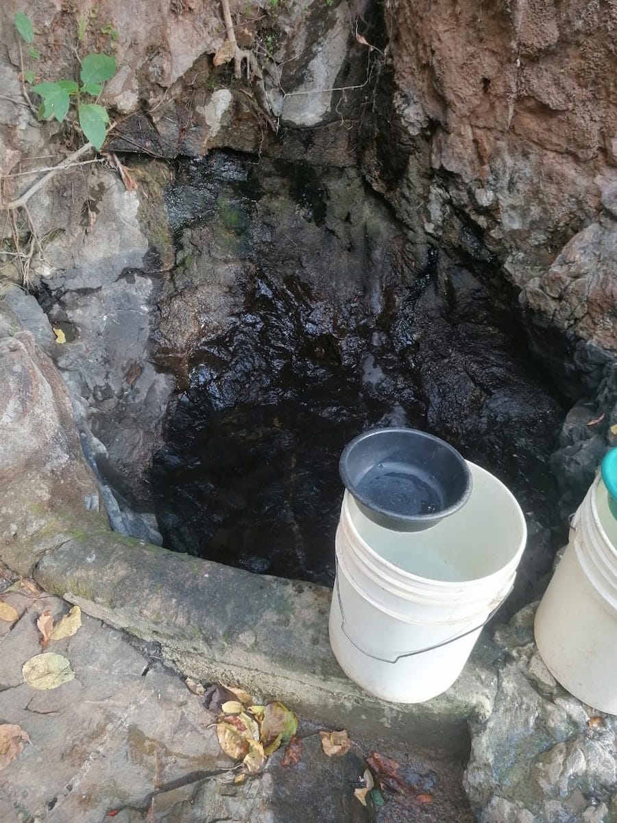 a stone well with buckets on the ledge