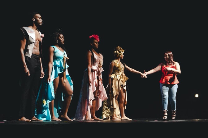 Students on stage at a fashion show