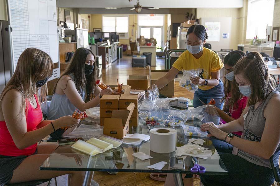 Students separate supplies at a table