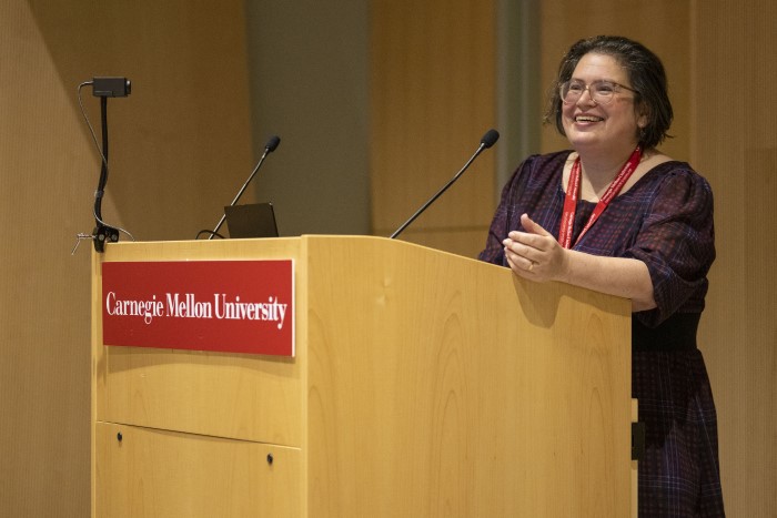 An image of a speaker standing at a Carnegie Mellon University podium.