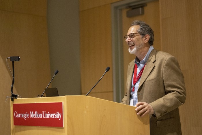 An image of a brainplay conference speaker standing at the podium.