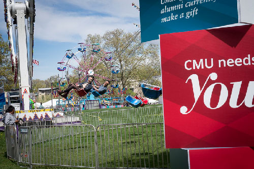 Students riding a carnival ride during Spring Carnival