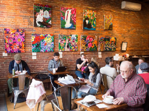 People sitting in Espresso A Mano coffee shop drinking coffee