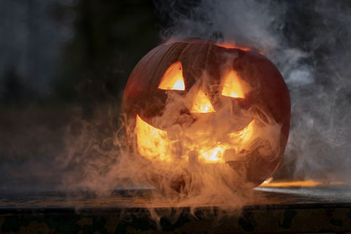 Orange pumpkin on a table with fog