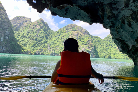 student kayaking in a cave on a study abroad experience