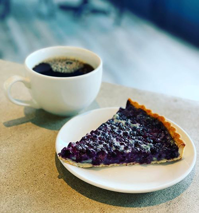 Picture of blueberry tart and coffee cup