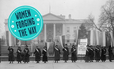 Black and white photo of womens sufferage protesters infront of the White House with logo in top corner for Women Forging the Way