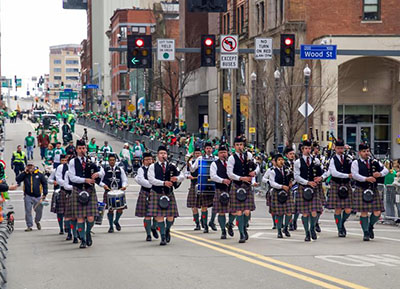 Image of carnegie mellon's pipes and drums band marching in the st. patrick day parade