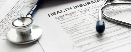 Health insurance documents and stethoscope