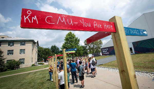 Directional sign on campus with foreign country names that says "You are here"