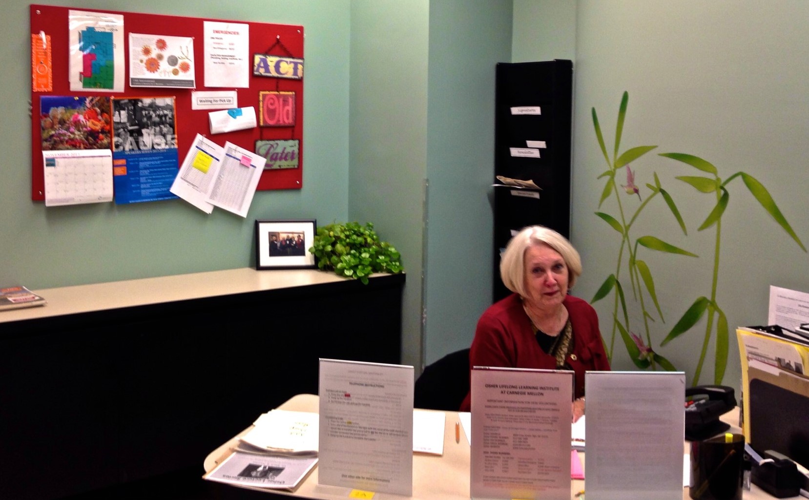 Gail sitting at Osher's front desk