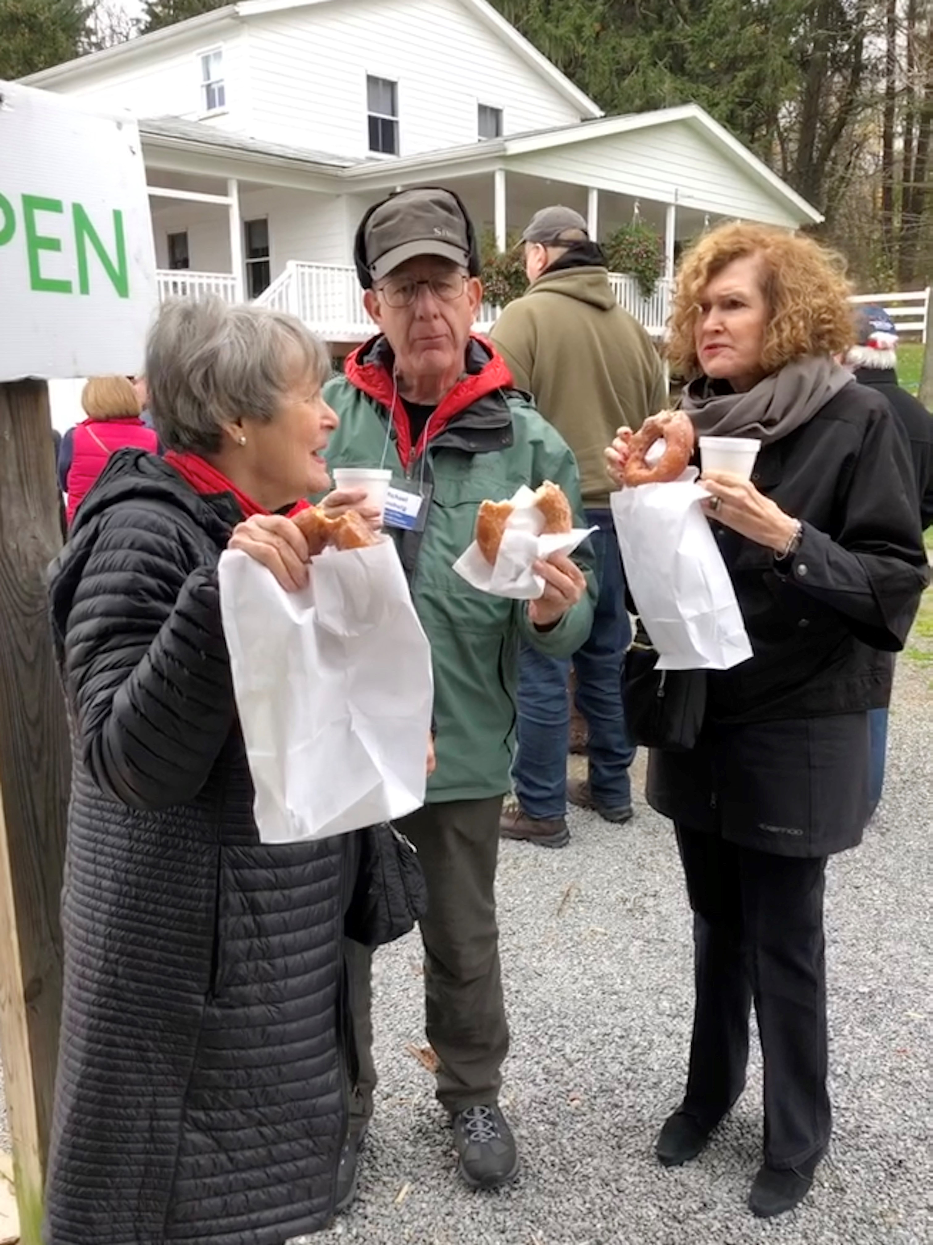 Trip goers eating apple cider donuts