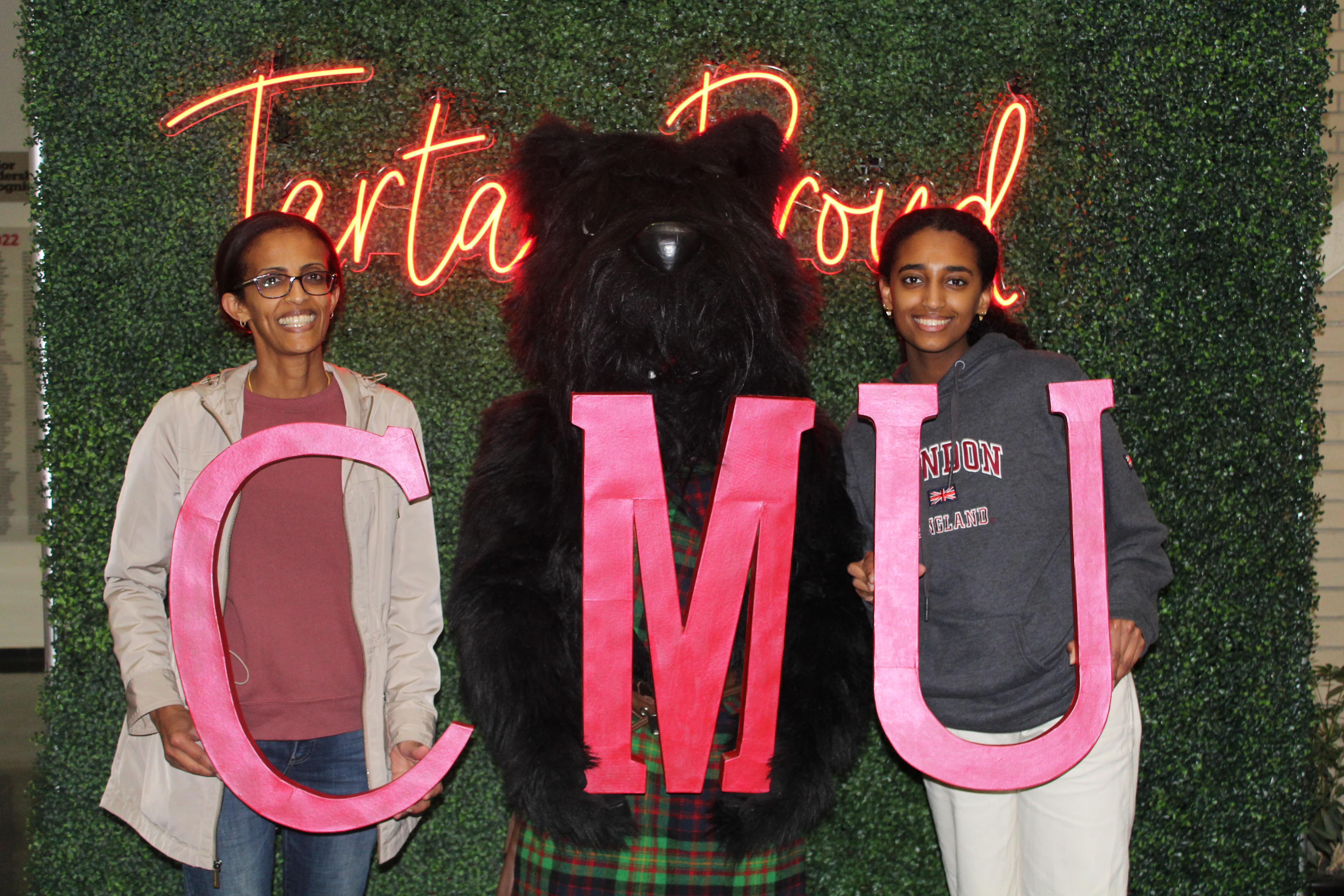 Scotty dog posing with CMU family members and students