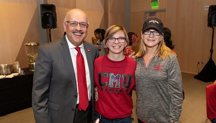 photo of CMU student and family member with President Farnam Jahanian