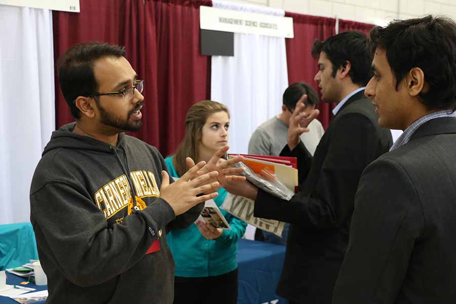 Photo of a student and career adviser chatting at a Career Fair