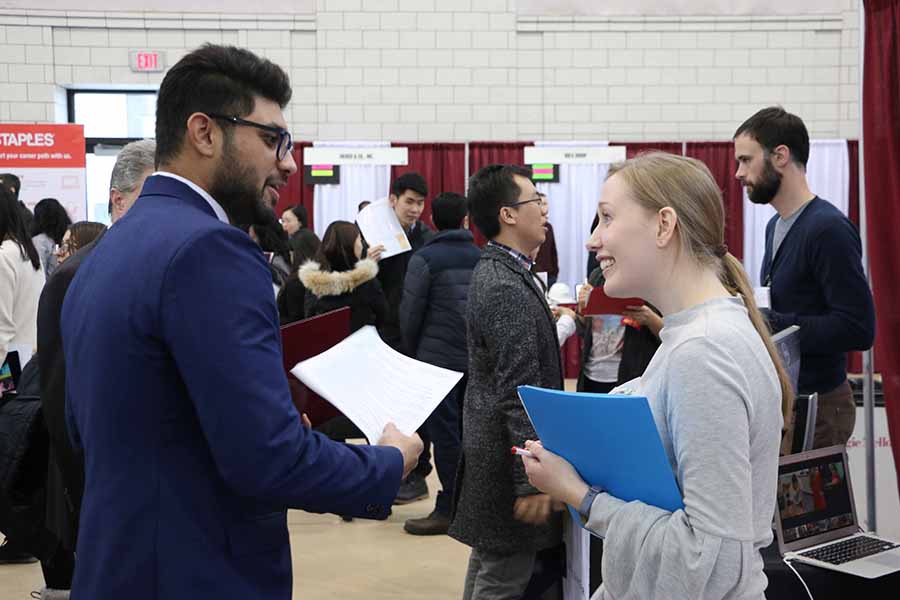 Photo of a student and career adviser chatting at a Career Fair