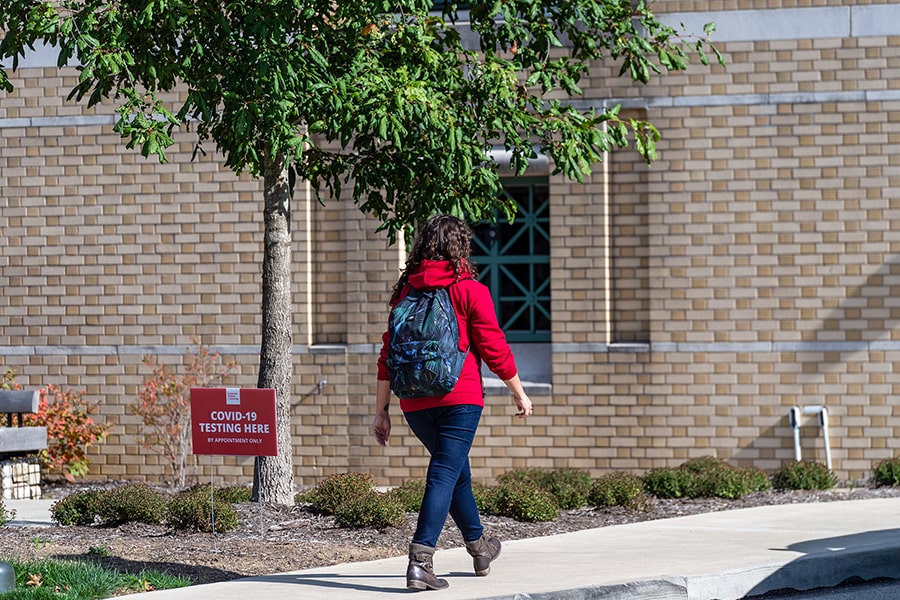 a student walking in to get screened for COVID-19