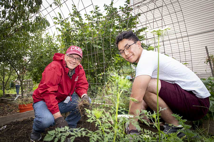 photo of CMU Provost Jim Garrett and student working in the university garden