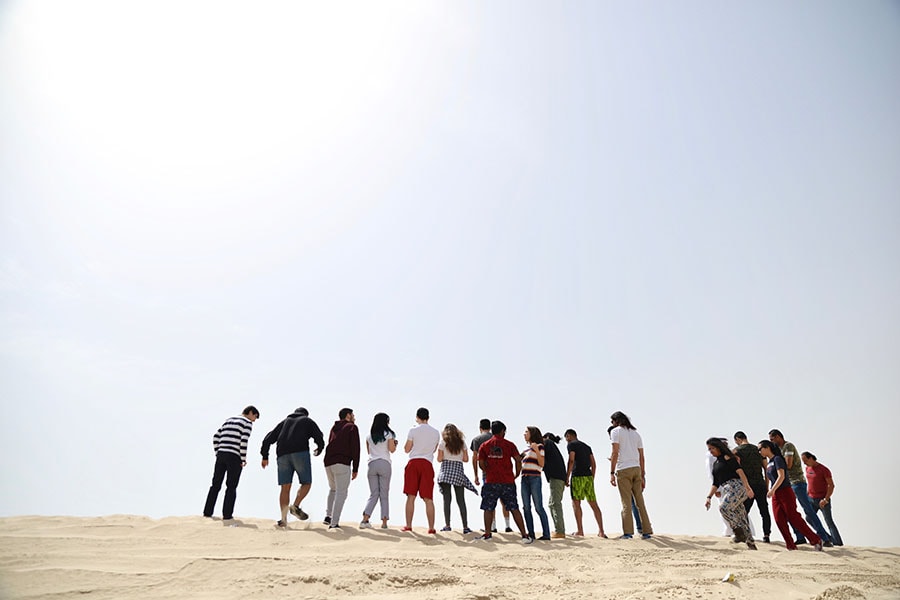photo of students standing in the desert