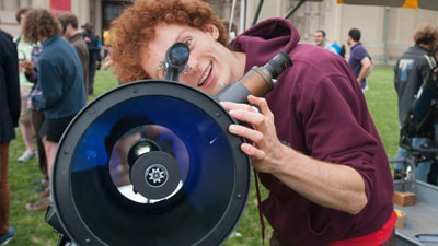 Student looking through telescope