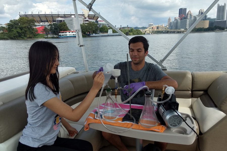 image of students taking water samples from Pittsburgh's three rivers