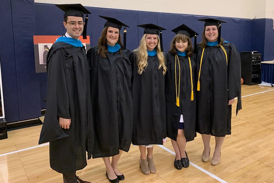 image of Rachel Dolcich and fellow staff graduates