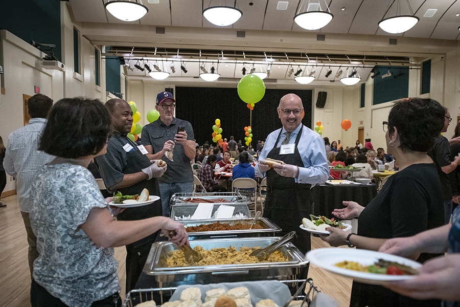 image of Farnam Jahanian serving at the buffet line
