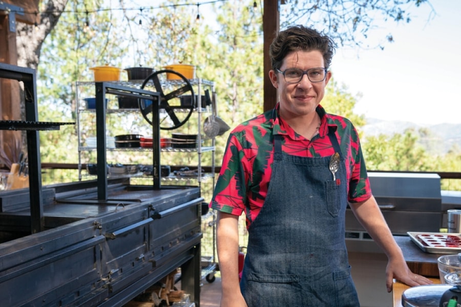 portrait of celebrity chef Justin Warner in an outdoor kitchen