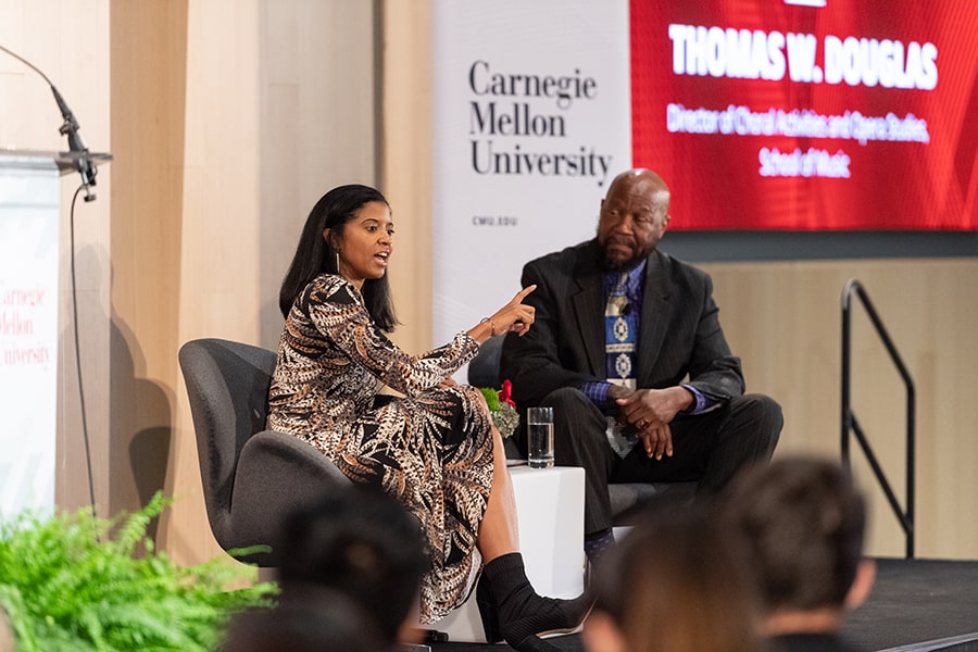 image of Renee Elise Goldsberry and moderator Thomas Douglas on stage during the Tartran Community Day's opening event 