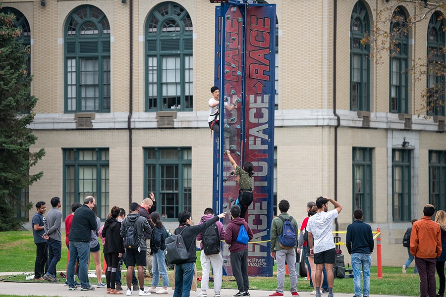 image of two students racing up the rock climbing wall