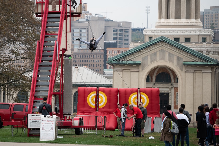 image of a person upside down riding the zip line