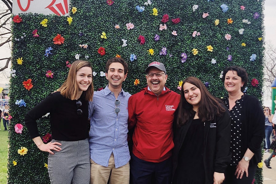 group photo of President Farnam Jahanian, Vice President Gina Casalegno and students from last year's Spring Carnival