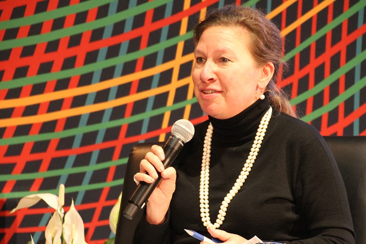 Image of Sarah Mendelson speaking into a microphone during a panel discussion