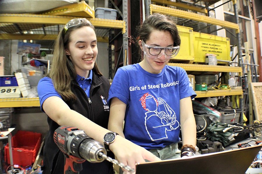 image of Shannon Werntz working with a student on the Girls of Steel