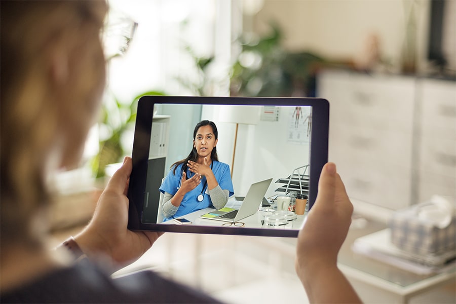 image of person looking at healthcare worker on iPad