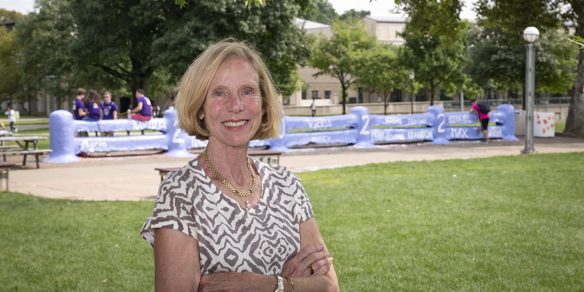 portrait of Anne Witchner standing in front of the Fence